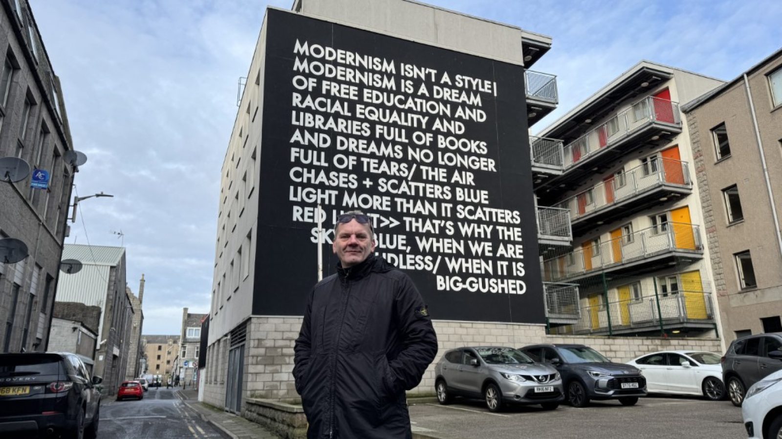 Martyn at the text-based Robert Montgomery mural at Jopps Lane created for the first Nuart Aberdeen in 2017