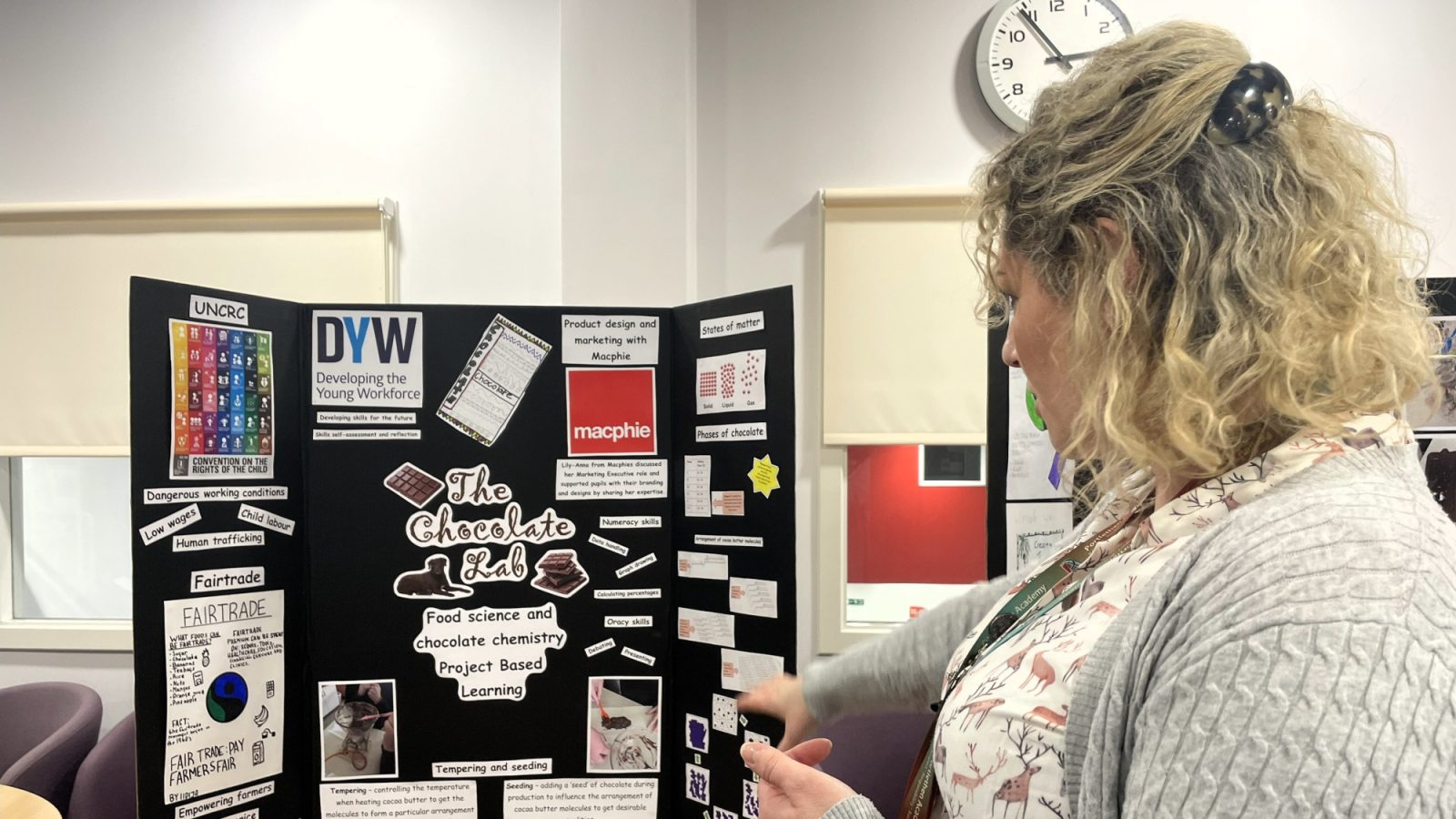 Teacher Emma Livesey with one of the final project displays, including pupils’ research findings, posters and chocolate products.