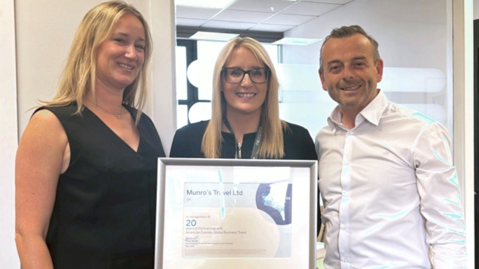 From left, Claudia Birtwisle of American Express Global Business Travel presented Cheryl Henderson, Head of Operations and Murray Burnett, Managing Director of Munro's Travel with a commemorative award