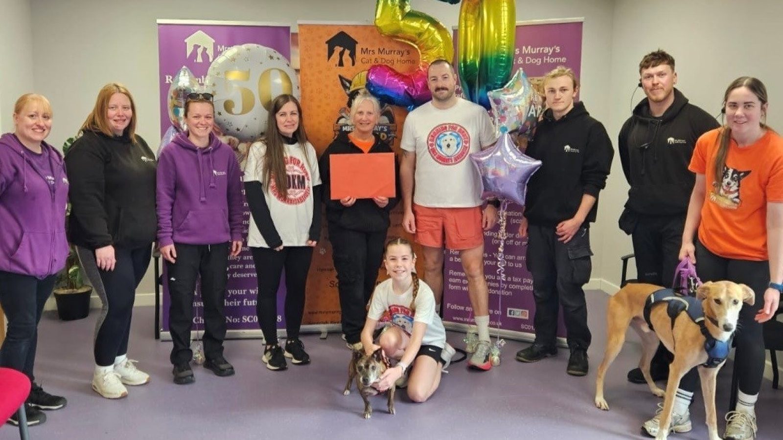 Eleven-year-old Abigail MacBeath (front and centre, with Pookie the dog) celebrates completing her 50km fundraising challenge at Mrs Murray’s Home for Stray Dogs and Cats, undertaken in memory of her much-loved dog and best friend.
