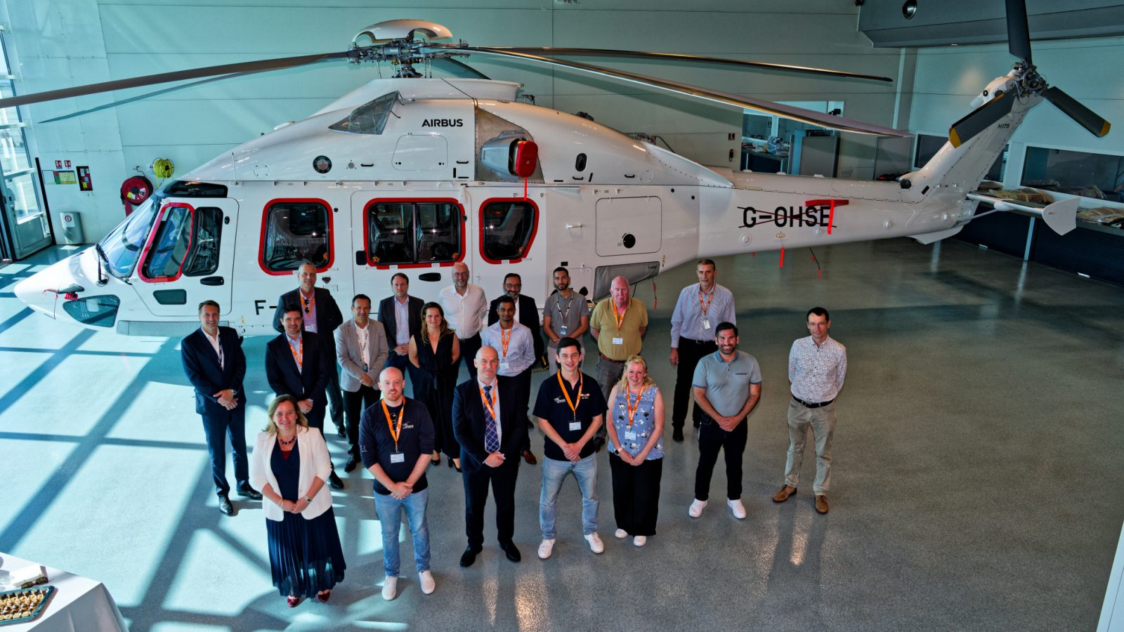 Shaun Roseveare, Ultimate Aviation Group CEO, middle row, second from the left, and Chris Krajewski, OHS Executive Director, back row (closest to helicopter) first on left.