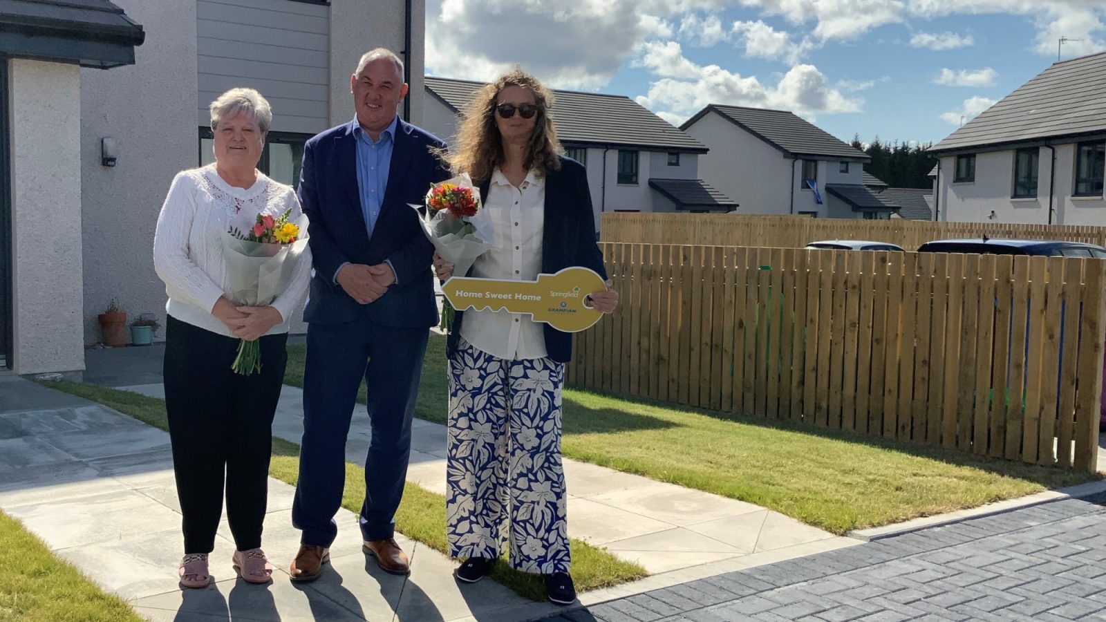 Pal McLennan Housing Minister with new tenants